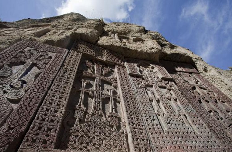 a row of khachkars at Geghard Monastery
