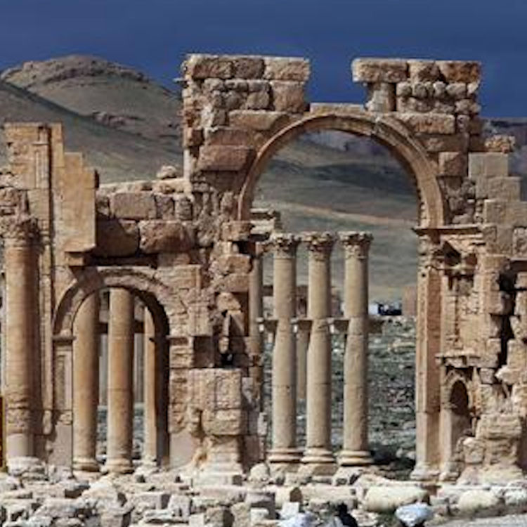 A file picture taken on March 14, 2014 shows visitors walking near the famous Arch of Triumph of the ancient oasis city of Palmyra, 215 kilometres northeast of the Syrian capital Damascus. AFP Photo