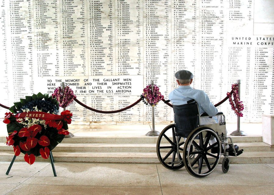Pearl Harbor survivor Bill Johnson reads the list of names inscribed in the USS Arizona Memorial.