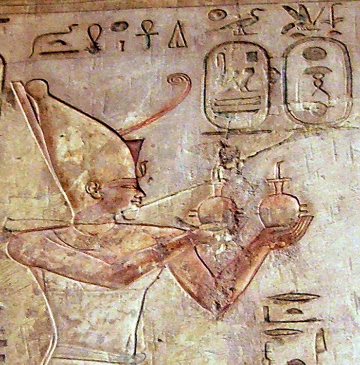 Psammetichus I adoring Ra-Harakhte - Pabasa's tomb in the Theban Necropolis - 26th dynasty of Egypt. Using the milk-jug hieroglyph in text in front of Pharaoh, (and two milk jugs in hands): "Making (offering of) Milk". Image credit: Wikipedia