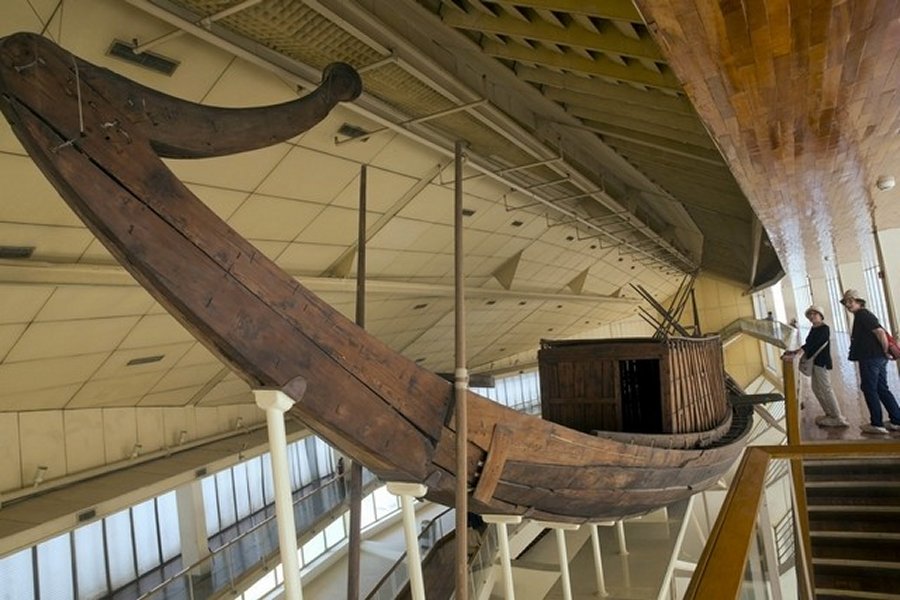 Tourists visit the ancient Pharaoh king Cheops' first solar boat, which was removed in pieces in 1954 and painstakingly reconstructed, during their visit to the boat museum at the Pyramids site in Giza, Egypt, Wednesday, March 29, 2017. (AP Photo/Amr Nabil)