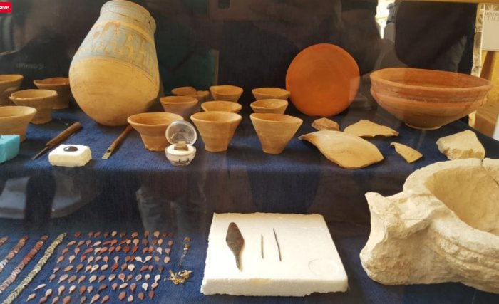 Various finds including ring, metal objects and pottery vessels.