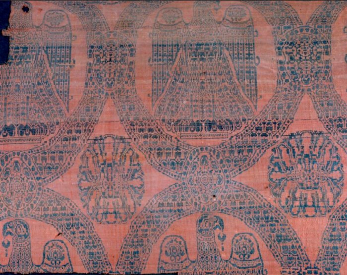 The Eagle Silk blanket was originally 195-230 cm wide, but today the remains measure 110 cm high and 133 cm wide. It is woven as samite, a fine weaving technique developed in Sasanid Persia (AD 226-661). The original colors were dark blue, dyed with woad and indigo, and red, dyed with madder and sappanwood. Credit: Nationalmuseet/The National Museum of Denmark