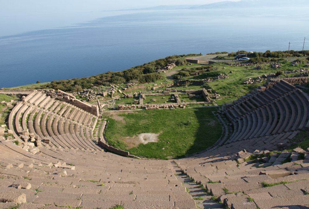 The ancient Theatre of Assos overlooking the Aegean Sea, with the nearby island of Lesbos on the horizon, at right.